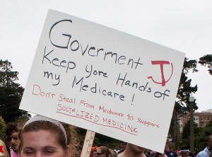 Tea party rallier holding up mispelled sign: Goverment keep yore hands off my Medicare!